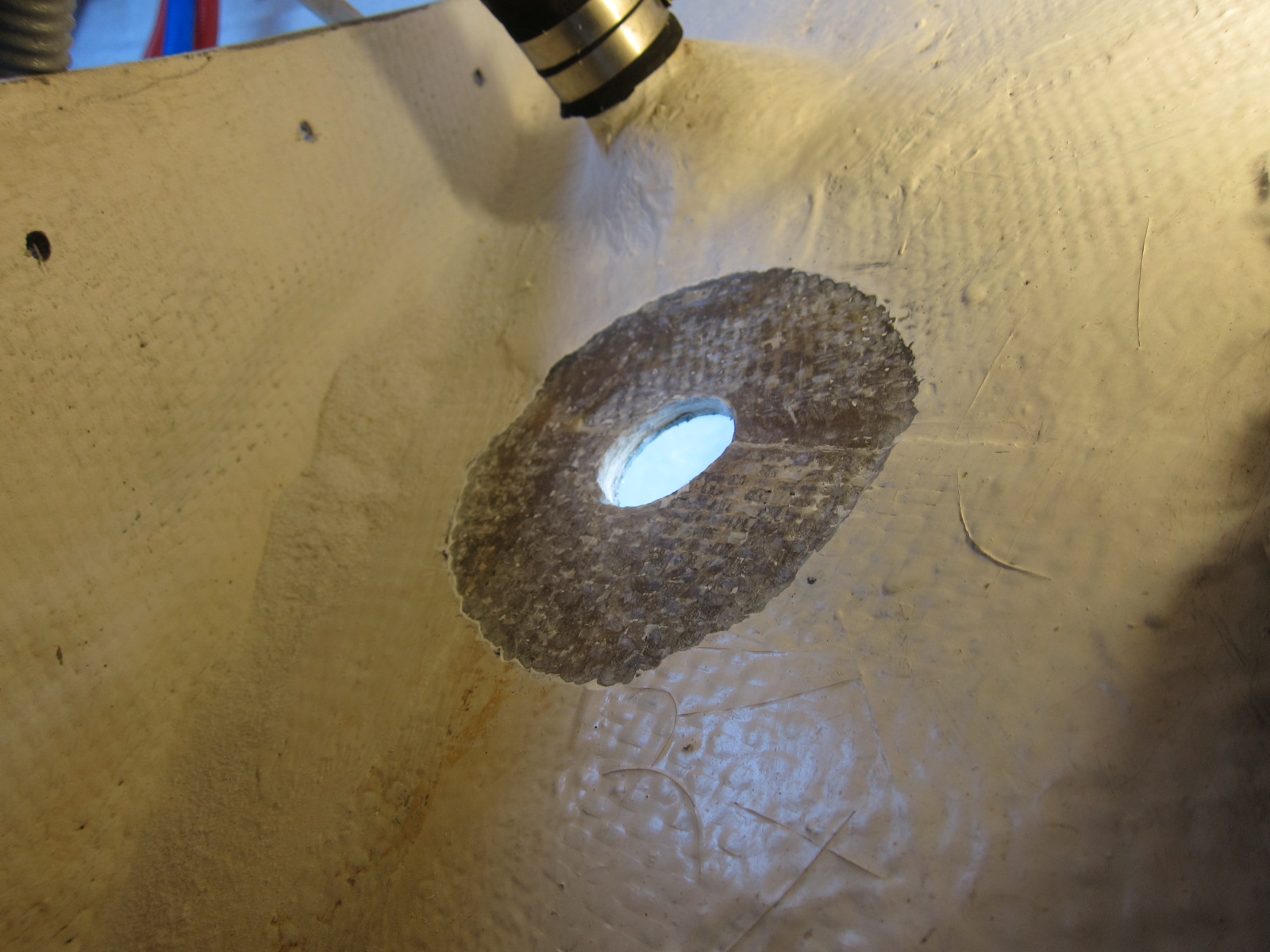 Removed gelcoat to expose fiberglass hull for epoxy.