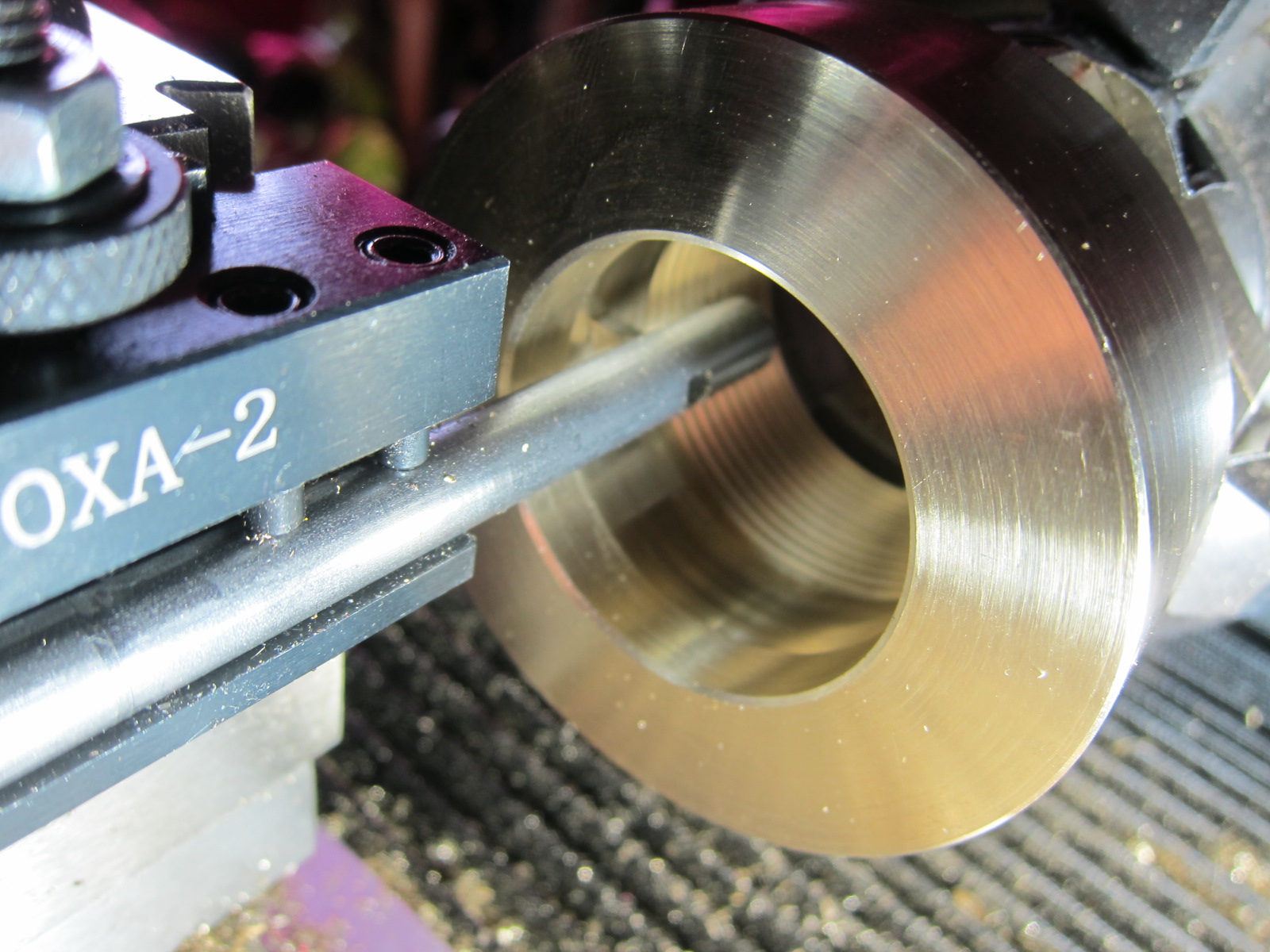 Using the lathe to cut the threads and hollow out the inside.